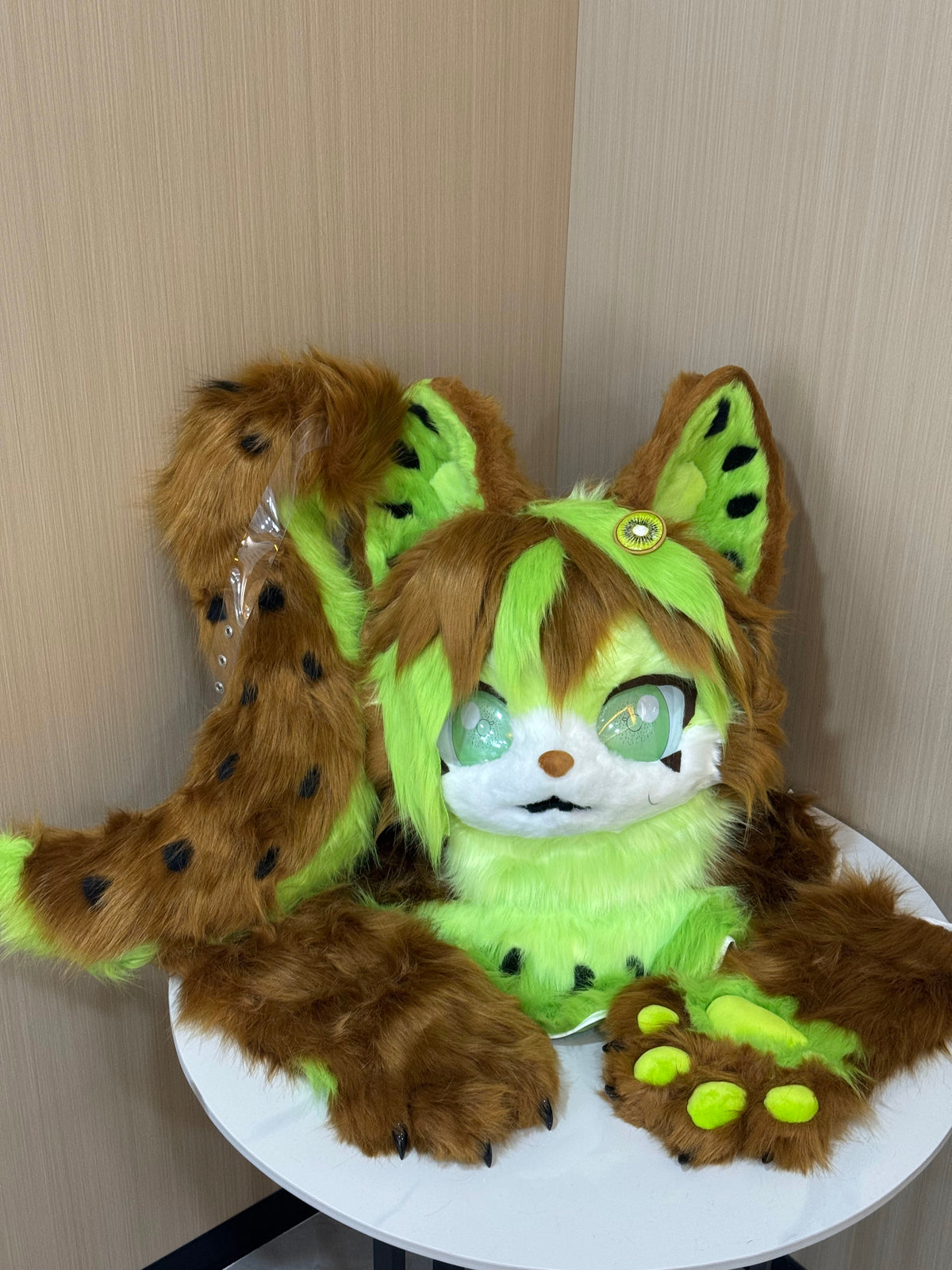 Brown and lime green leopard cat fursuit head and paw detail