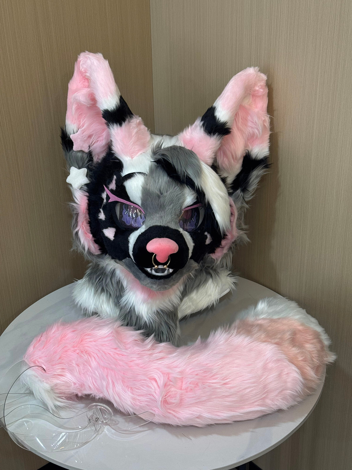 Pink and black cat fursuit head with pink muzzle and septum ring close up