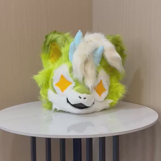 Lime green kemono fursuit head turning to show the ear and horn detail — video