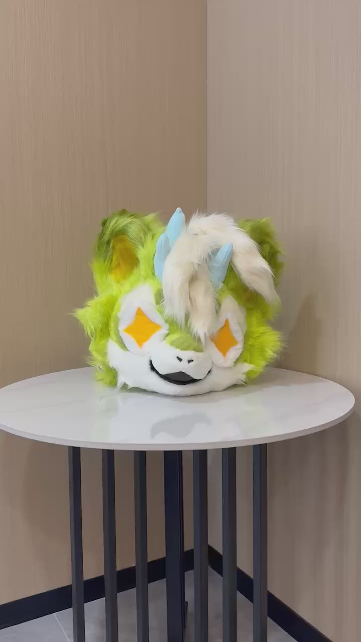 Lime green kemono fursuit head turning to show the ear and horn detail — video